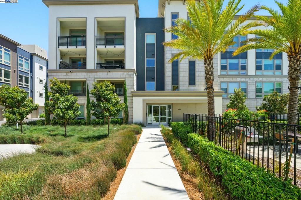 EAST facing front door. Live the Resort Life without leaving home. Welcome to the pinnacle of condo living. Single Story, private elevator, Modern, 2 car attached garage. Designed by KTGY in 2022 step into this luxury private elevator-served flat at Hyde Park, and you can feel the sense of belonging. With only 2 units on each floor, each unit enjoys sunlight on all 3 sides of the building. Smart construction is utilized and these buildings are built to last using 3-coat stucco and 1.5” concrete between units with 9 feet ceiling throughout providing superior noise and thermal insulation. Ultra efficient split unit heat pumps are installed in each room utilizing low energy and carbon footprint for the entire unit. That is everything you want in a home. Enter into a bright, open-concept space that brings everything together. Look out onto the 14,500 sq ft clubhouse and heated swimming pool from the covered deck just off the dining room. Retreat to the luxe owner suite with stunning appointments and a walk-in closet. This new home for sale in Dublin offers a new urban kind of single-level living – while a private elevator entrance and sleek features add to that extra hint of sophistication. Don't forget to check out the 2 side by side garage on the first floor with EV charger.