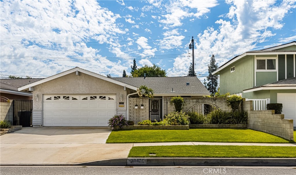 Tremendous opportunity in Lakewood! Charming single story home with great curb appeal and location in wonderful Lakewood neighborhood! This beautiful home has entry through an enchanting courtyard and offers a spacious floorplan with 4 bedrooms/1.75 bathrooms, living room with cozy fireplace and adjacent dining area, and delightful kitchen with breakfast bar that opens up to the dining and living areas. This meticulously maintained home offers upgraded windows, beautiful glass entry door, charming French doors, stunning French sliding glass door, newer heating and central air conditioning (just installed this summer!), newer roof, and central vacume system. The outdoor living is ideal for entertaining with a covered patio, as well as an enclosed patio with handsome wood beam ceiling, and backyard with green grassy area. There is also a drywalled 2 car garage with an upgraded garage door. This home is conveniently located to freeways, Rynerson park, dog park, and shopping/restaurants. All of this and so much more including the Blue Ribbon School of Artesia High School!