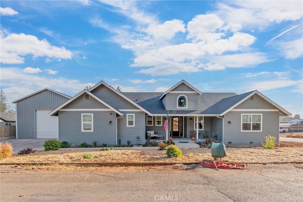 Located just minutes from the scenic beauty of Bille Park, this beautiful 3-bedroom, 2.5-bathroom home blends comfort, style, and functionality in a quiet, desirable location. Step inside to find a spacious open-concept living area, highlighted by a freestanding wood-burning stove—perfect for cozy evenings. The elegant kitchen is a chef’s dream, featuring LG stainless steel appliances, a gas range, a second built-in oven, microwave, and stunning quartz countertops. You’ll love the oversized stainless-steel sink and large island with bar-top seating—ideal for casual meals or entertaining. Just off the kitchen, you'll step outside onto a 306 sq ft covered deck with a ceiling fan—perfect for relaxing or hosting guests while overlooking your blank slate backyard, perfect for a garden, play structures, or other personal touches. The rest of this half of the home holds the laundry room, half bathroom, and entry to the attached garage. The second half of the home houses all three bedrooms and two bathrooms. The hallway bath showcases black and white tile, quartz counters, and a large clawfoot tub. The spacious primary suite offers direct access to the back deck, dual closets (including a walk-in closet with built-in dresser.) The attached primary bath features dual vanities, a water closet, and a luxurious walk-in shower with dual shower heads. Modern comforts include a whole house fan, instant hot water heater, and a fire sprinkler system. The biggest attraction is a massive 1,500 sq ft detached metal shop—complete with roll-up doors, abundant storage space, and even its own bathroom—perfect for hobbyists, mechanics, or entrepreneurs. Don’t miss this rare blend of location, amenities, and space. Come see all this home has to offer.
