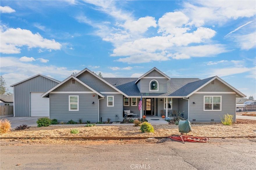 Located just minutes from the scenic beauty of Bille Park, this beautiful 3-bedroom, 2.5-bathroom home blends comfort, style, and functionality in a quiet, desirable location. Step inside to find a spacious open-concept living area, highlighted by a freestanding wood-burning stove—perfect for cozy evenings. The elegant kitchen is a chef’s dream, featuring LG stainless steel appliances, a gas range, a second built-in oven, microwave, and stunning quartz countertops. You’ll love the oversized stainless-steel sink and large island with bar-top seating—ideal for casual meals or entertaining. Just off the kitchen, you'll step outside onto a 306 sq ft covered deck with a ceiling fan—perfect for relaxing or hosting guests while overlooking your blank slate backyard, perfect for a garden, play structures, or other personal touches. The rest of this half of the home holds the laundry room, half bathroom, and entry to the attached garage. The second half of the home houses all three bedrooms and two bathrooms. The hallway bath showcases black and white tile, quartz counters, and a large clawfoot tub. The spacious primary suite offers direct access to the back deck, dual closets (including a walk-in closet with built-in dresser.) The attached primary bath features dual vanities, a water closet, and a luxurious walk-in shower with dual shower heads. Modern comforts include a whole house fan, instant hot water heater, and a fire sprinkler system. The biggest attraction is a massive 1,500 sq ft detached metal shop—complete with roll-up doors, abundant storage space, and even its own bathroom—perfect for hobbyists, mechanics, or entrepreneurs. Don’t miss this rare blend of location, amenities, and space. Come see all this home has to offer.