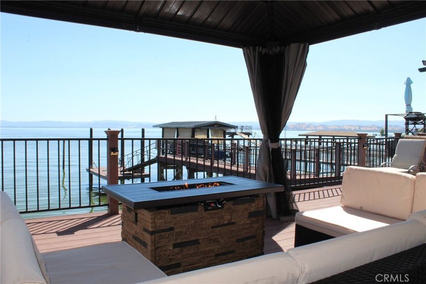 Discover the perfect blend of comfort, style, and investment potential in this exceptional 2-bedroom, 2-bath waterfront retreat. Whether you’re seeking a full-time residence, a weekend escape, or a passive income opportunity, this home offers breathtaking views, direct water access, and turnkey rental potential.



Currently a family and friends vacation spot. When not in use by family, it still has yielded as a very successful fully furnished short-term rental on Airbnb, Vrbo, and Booking.com.  Each bedroom features its own private bath — perfect for guests, traveling professionals, or multi-generational stays. Built with lasting quality, the property includes a solid seawall and full construction documentation.



Relax outdoors on the expansive lit deck or escape down the ramp to your private swim platform and side tie your water vessel— ideal for fishing, swimming, or lounging on the lake. The beauty within includes granite countertops, custom cabinetry, and an imported Italian gas range stove. Additionally, the bathrooms feature granite tile, upscale fixtures, and elegant cabinetry.



Cozy up by the fireplace, enjoy easy parking, and take advantage of the unbeatable location — just over 200 yards from parks, a public boat ramp, along with shopping and dining nearby. Whether you want a serene lakefront permanent residence, retreat or a profitable Airbnb/Vrbo/Booking.com business, this rare opportunity is ready for you.