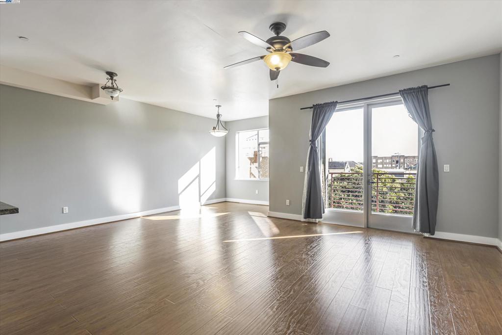 This contemporary, spacious, and bright East-facing condo offers a perfect blend of comfort and style in a securely gated building. Featuring lofty 9-foot ceilings, an open floor plan, and beautiful hardwood floors extending through the living and dining areas, this home is both elegant and inviting. The private balcony overlooks the serene courtyard, adding a touch of tranquility. Additional highlights include: In-unit stacked laundry; A deeded street-level garage parking space. The pet-friendly building offers secure entry and an elevator for convenience. The HOA covers water, sewer, trash removal, and high-speed internet! Perfectly located, this condo is just a short walk to BART, Lake Merritt, Laney College, Jack London Square, and the Amtrak station. Truly a Walker's Paradise!