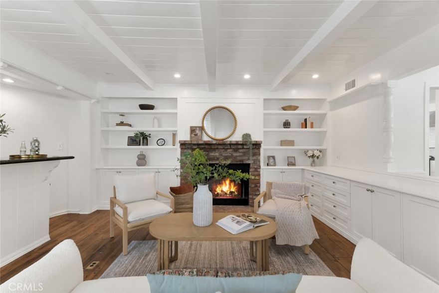 Located south of Ventura Boulevard and west of the 405 Freeway, this remarkable residence sits along the picturesque Strawberry-Adlon loop, a quiet, tree-lined street with minimal pass-through traffic. Nestled on a bluff surrounded by lush greenery and anchored by a towering redwood, the property offers a unique sense of privacy and tranquility. Within the highly rated Lanai Road Elementary School boundary, the home features 4 bedrooms, 3.5 bathrooms, and just over 2,900 sq ft of living space on a 19,200 sq ft lot, blending timeless character with thoughtful updates. Recent improvements include new fire-rated roof, exterior stucco, and vents, and all new interior paint. Natural light streams through diamond lattice windows, highlighting hardwood flooring throughout most of the home, brand-new tile in the kitchen and powder bath, and new carpeting in the guest wing. The formal entry opens to a living room with fireplace, beamed ceilings, and expansive windows, flowing into a formal dining room and family room, both showcasing architectural charm. The family room offers a second fireplace, wet bar, built-ins, and direct access to a spacious rear courtyard that stretches the length of the property. The generous kitchen features granite countertops, a prep island with sink, pantry with antique natural wood doors, and top appliances including a Thermador 6-burner range with griddle and double oven, Viking hood, and Sub-Zero refrigerator. A small, enclosed courtyard off the kitchen with pet door provides a safe outdoor retreat for pets. The adjacent laundry room leads to a private guest wing with 3/4 bath and bedroom, ideal for guests, in-laws, or tenants. The main hall connects to three additional bedrooms, including a primary suite with vaulted ceilings, dual closets (one walk-in), French doors to a private patio and pool, and a spa-like bath with walk-in shower and raised jetted tub. Two secondary bedrooms share a 3/4 hall bath with direct access to one. Outdoors, the expansive courtyard, heated pool, and wraparound patio offer a serene setting surrounded by trees and landscaping—perfect for hummingbird sightings by day and owls at night. In addition to Lanai Road Elementary, the home offers close proximity to shopping, dining, and entertainment along Ventura Boulevard, outdoor recreation at the Encino Reservoir and nearby trails, plus quick access to Hayvenhurst, Mulholland, Sepulveda, and the 405 Freeway.
