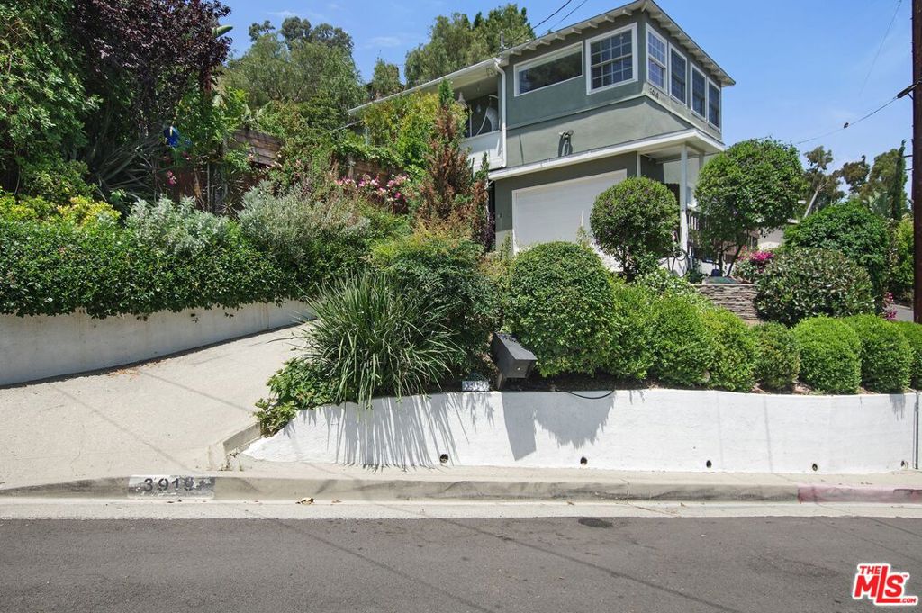Welcome to your private oasis in the heart of Glassell Park! This lovely three bedroom and three bath traditional home has an inviting light filled den with wrap around windows, and an open kitchen with a built in dining banquet, perfect for relaxing dinners and entertaining. The spacious en suite master feels luxurious and cozy. The third bedroom with attached bathroom, and kitchenette, has a private entrance making this an excellent live/work space or guest suite. In the back yard you'll enjoy the Sonos surround sound, while soaking in the hot tub which is nestled into beautifully maintained and terraced gardens above a large deck. Lush gardens surround the entire property. Al Fresco dining is enhanced by the 180 degree vistas in the distance, lounge seating, and the fire pit. The two car garage and long driveway provides ample parking. Conveniently located to freeways with quick access to Silverlake, Highland Park, and Atwater Village. Come experience this special home!