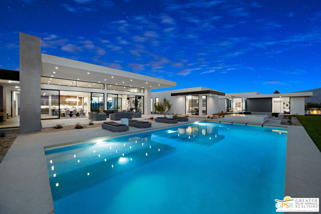 Introducing 3 Wren Court - the final and most expansive offering in this exclusive enclave of contemporary estates in Rancho Mirage. Set on a commanding 1.75-acre lot, this brand-new architectural residence redefines desert luxury with bold design, refined finishes, and resort-quality amenities. At the heart of the home is a dramatic open-concept layout designed for effortless indoor-outdoor living. Walls of glass frame panoramic mountain views and open to a resort-style saltwater pool with infinity-edge spa, sculpted desert landscaping, and expansive entertaining areas. Every detail is thoughtfully considered, from the expansive great room with panoramic sliding glass doors to the gourmet kitchen featuring top-of-the-line Dacor appliances, a separate butler's kitchen for seamless hosting, and a stylish wet bar complete with wine refrigeration. The main residence offers a grand primary suite with a spa-like bath, including indoor and outdoor showers and a soaking tub, as well as two guest suites with private en-suite bathrooms and a shared sitting room, ideal for hosting family or friends. A versatile flex room provides space for a home theater, personal gym, or private office. A detached guest house offers its own living area and total seclusion from the main home, making it perfect for extended stays or added privacy. Additional highlights include a private motorized gate and long driveway approach, a fully owned solar system with backup battery, a Control4 smart home automation system, a custom-designed fire feature, built-in barbecue, and an air-conditioned garage with generous capacity. Built as the pinnacle of the collection, 3 Wren Court is more than just the final home, it's the estate that brings the vision full circle. An uncompromising blend of architectural sophistication, privacy, and desert serenity awaits.