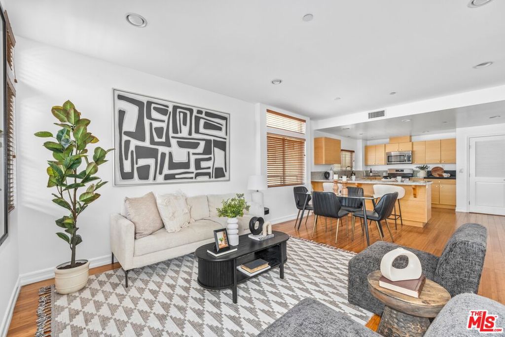 Bright and stylish 2 bed, 2.5 bath corner unit at 3509 Keystone Ave #101, located in a secure, modern building in the heart of Palms. This thoughtfully updated condo features an open floor plan with rich bamboo flooring, oversized windows, and incredible natural light throughout. The spacious living and dining areas flow seamlessly to a private patio, perfect for morning coffee or evening unwinding. The sleek kitchen offers granite countertops, new stainless-steel appliances, and generous cabinetry for storage and prep. The oversized primary suite includes a walk-in closet and spa-like bath with a large vanity, soaking tub, and separate shower. The second bedroom is well-sized with access to a full guest bath, offering an ideal layout for privacy and comfort. Additional highlights include in-unit laundry, central HVAC, custom closet built-ins, and two subterranean parking spaces in a gated garage. Set in a prime Palms location, you're just minutes from downtown Culver City, Sony Studios, and the tech and media hub of the Westside. Enjoy easy access to the Expo Line, major freeways, and a vibrant mix of neighborhood favorites, from trendy cafes and local markets to fitness studios and beloved eateries along Venice Blvd, Motor Ave, and Washington Place. Whether you're commuting or exploring, this home places you right in the center of it all.