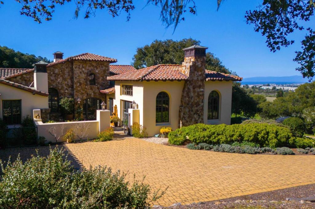 Nestled on Paseo Vista Drive in the highly coveted Monterra Ranch community, this custom one-story home is a true masterpiece. From handcrafted fireplaces and wood beams, to ironwork tailored specifically to the home, this residence defines luxury living. Visitors are greeted with high ceilings, a chef's kitchen, and ample room for entertaining. While each of the four bedrooms offer ensuite bathrooms, the primary bedroom pampers owners with a spacious walk-in closet, elegant bathroom, inviting fireplace, and breathtaking ocean views. The property also boasts a versatile home office, large laundry room, and an efficient air conditioning system, making this home a true sanctuary in any season. Bask in the multiple outdoor patios offering three fireplaces, multiple fountains, and a built-in BBQ area. The back patio highlights the natural terrain focused on the stunning views of Monterey Bay to the Santa Cruz mountains. This one-of-a-kind home is ready to meet all your lifestyle needs and should not be missed.