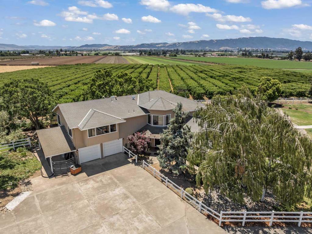 Live, Work, Play at Lazy K Ranch! Discover a rare opportunity to own this beautifully maintained 11.54 acre country estate in Gilroy's scenic countryside. Enjoy 360 degree views, a 4,200 sqft main home (4 bed/4 bath), and two income-producing guest houses: a charming 1 bed/1 bath Red Cottage (495 sqft) and a 2 bed/1 bath guest home (925 sqft), each with private entries and yards. Zoned AW, this versatile property includes a 7.23 acre U Pick cherry orchard, a beloved seasonal agritourism destination. This property has the capacity for multiple RVs, trailers and parking. Horse enthusiasts will appreciate the barn with 5 stalls (potential), breezeway, and fenced paddocks. Car lovers and hobbyists will enjoy 2 workshops and 3 garage bays in the Barn and 2 car garage attached to home. Ideal for multigenerational living, an active family, or investors seeking a rural retreat with diverse revenue streams and agricultural potential. Live luxuriously while earning income from rentals and orchard operations all in one exceptional estate. True Pride of ownership with many upgrades (full copper pipe, quality flooring, updated kitchen and much more ) Only 11 mins to Caltrains for the commuter with easy access to Silicon Valley. Buyer to Verify All Data All Sqft and Acreage is Approximate.