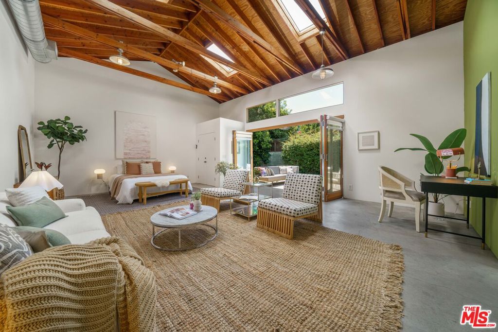 A unique Live/work Residential property offers both a charming 2+1 Calif. Bungalow with an oversized permitted Recreation/Studio space (approx 670 sf) located on a large lot in one of Valley Village's most sought-after cul-de-sac-like neighborhood streets. The light and bright home features newly refinished natural white pine hardwood floors, freshly painted interior, a welcoming foyer, a spacious living room, and a separate central dining room with access to a large, private, fenced grassy yard and patios. A delightful kitchen with a window-sink and an attached laundry room with access to a long driveway capable of holding multiple vehicles with a two-car garage at the end. One of the two bedrooms features a walk-in closet with direct access to a full bath, including a separate shower and tub. Built in 2005, the oversized Recreation/Studio Space is attached to the two-car garage, which would make an excellent ADU conversion and bring the total area, including the main house, to over 2,000 sq ft! Designed initially as a photographer's studio accommodating large-scale art, equipment, etc., this multifunctional space has a separate exterior entrance, 3/4 bath, soaring skylit wood-beamed ceilings, along with an expansive four-door opening to yard and patio space. Located in an area of Valley Village offering two Elementary School options: Colfax Charter or Riverside Drive Charter Elementary.