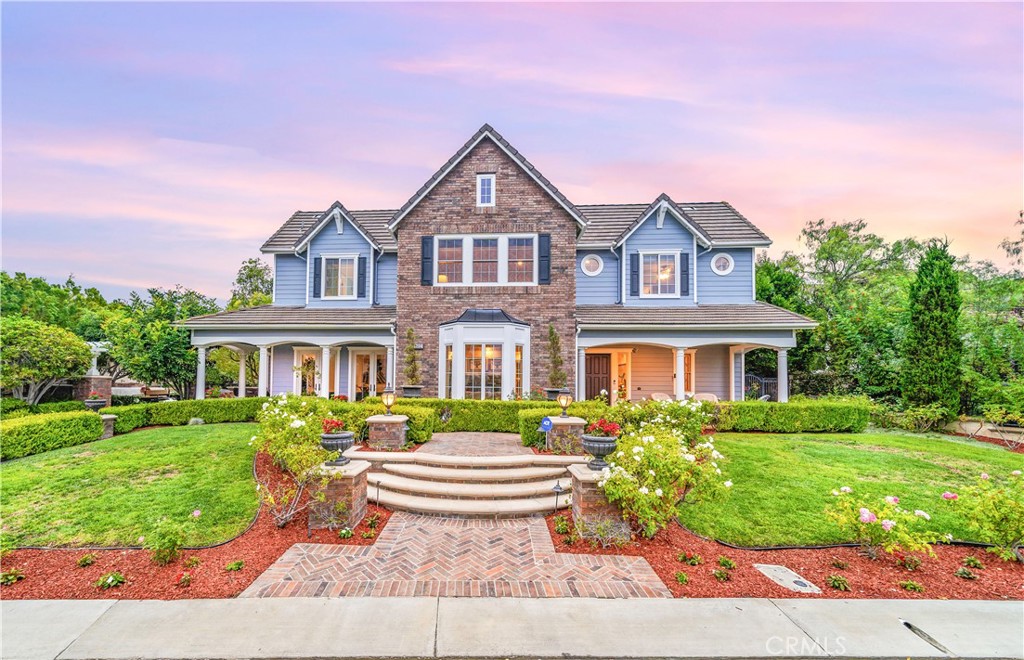 Nestled within the prestigious equestrian community of Nellie Gail Ranch, this meticulously upgraded residence is situated at the heart of a quiet, tranquil, pride of ownership interior cul-de-sac. Spanning nearly 6,000 square feet, this traditional estate offers five bedrooms, five and one-half baths, a dedicated bonus room, billiard parlor, and upper library, providing an exceptional breadth of living spaces for distinguished residents and their guests. The already expansive interior is complemented by a magnificent exterior designed for opulent entertaining and recreation. A private lanai, adorned with sophisticated stone accents and a charming fireplace, sets the stage for al fresco dining and relaxed evenings. Beyond the lanai, a resort-style rock pool captivates with cascading waterfalls, a thrilling 35-foot slide, and a walk-in kiddie pool, ensuring endless hours of enjoyment. French doors invite a seamless transition to private interior courtyards, creating an elegant flow ideal for both intimate gatherings and grand celebrations. The billiard parlor provides a setting for engaging games, while the upper bonus room offers a secluded space for cinematic indulgence. Culinary artistry flourishes in the gourmet kitchen, equipped with a custom mastery stove hood, a spacious seating island, stainless steel appliances, abundant granite countertops, a convenient butler's pantry, and an integrated desk. The lavish primary suite serves as a serene retreat, featuring a romantic fireplace and a spa-inspired primary ensuite with its own private deck, perfect for peaceful morning escapes. Throughout the residence, exquisite interiors are a testament to superior design, showcasing coffered ceilings with custom details, Venetian plastered walls, elegant crown molding, designer paint, bespoke built-ins, sophisticated custom lighting, and stunning wood flooring, among numerous other refined elements. Beyond the boundaries of this exceptional property, residents of Nellie Gail Ranch enjoy an unparalleled lifestyle enriched by world-class amenities. The community boasts access to 25 miles of equestrian trails, a community clubhouse, tennis center with 12 championship courts, a swimming pool, and numerous parks and green spaces perfect for picnics and relaxation. Nellie Gail Ranch's convenient Laguna Hills location provides the tranquility of a semi-rural setting with easy access to the various vibrant attractions beloved by Orange County residents. Welcome home!