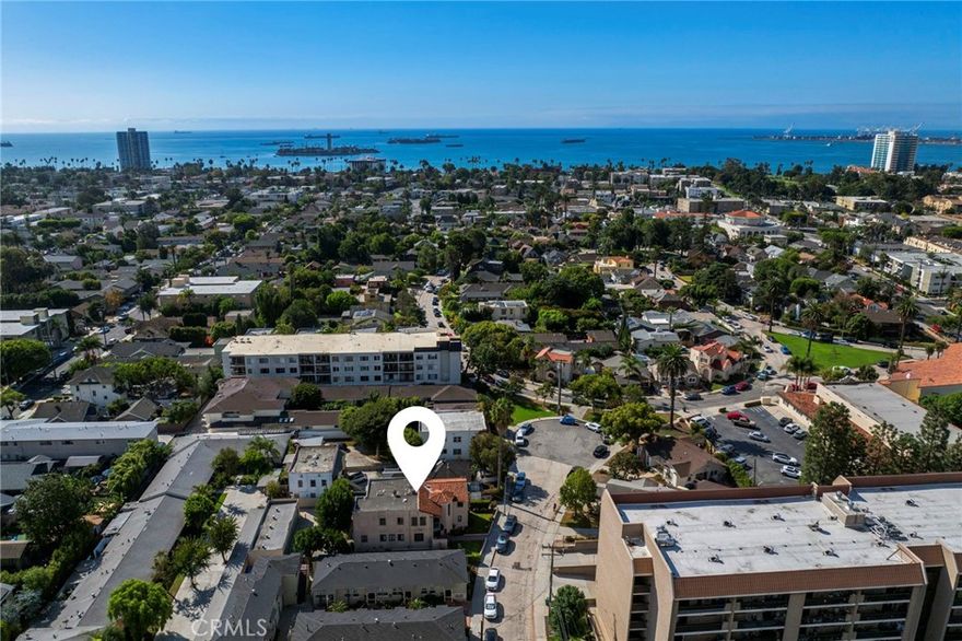 RARE Carroll Park pride of ownership fourplex with TWO FABULOUS OWNERS UNITS, a very good sized lot (7,723sf) and five garages.  Just MINUTES from the BEACH! Perfect for the savvy investor looking to add a prime property to their portfolio, an owner occupant (or two!), or someone looking for a hard to find well located property with room to build add additional units. Four bedrooms and four baths! This highly desirable location is not only close to the ocean, it’s on the border of the eclectic and fun “Retro Row” shops, galleries and restaurants and in historic Carroll Park, where beautiful tree lined streets showcase the diverse turn of the century architecture Long Beach is famous for.  Properties rarely come available here!  The whole place is brimming with cool architectural details - from the wood ceiling portico, custom tiled entry stairs, and large custom wood chandelier to the fabulous wood doors with wrought iron and stained glass details, arched doorways, double hung windows, fireplaces and built-ins throughout.  Each of the units is extra-large and has a highly desirable floor plan, abundant character and charm.  There are two shared laundry rooms, one on each floor.  The two owners’ units are fabulous.  Both had gut remodels of the kitchen and bathroom over the last few years.  One unit has a more vintage vibe with lots of custom tile work and a restored antique O’Keefe and Merritt stove.  So cool!  That unit also has a large private balcony in back.  The other boasts a more modern feel and has an open floor plan and super cute Juliet balcony. Both kitchens are gorgeous and have quartz counters, custom soft close cabinets, updated lighting, stainless appliances and ample cabinet and counter space.  Bathrooms have new vanities, new lighting, new fixtures and custom tile work.  Even the closets have been redone.  All of the units are light and bright with a large living room, lots of windows and fireplace.  Two of them have an alcove room perfect for a home office, the other two have a large pantry.  All the bathrooms and bedrooms are very good sized making the units super easy to rent.  A cute side yard gives outside space for the tenants to play and at the back, there are five garages.  The property has very low expenses and there is upside in the rents.  Hurry - this is a very special property and the location can’t be beat!