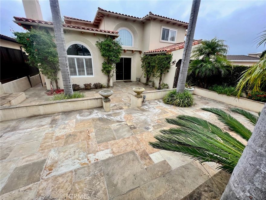 A Mediterranean beauty, at the peak of Hollywood Riviera Hills on a quiet tree lined street, views of Palos Verdes Estate Hills and peekaboos of Ocean from the top. Large, private, and sunken lot with multiple outdoor entertainment levels, totaling approximately 7,000 +- SQFT of usable living and entertaining space. Travertine and hardwood throughout, with a large kitchen with cooking island, and stainless steel appliances. Recessed ceilings and lighting, open, bright and grandly spacious feel. Formal living room, formal dining room, large sunny den, and a breakfast nook next to kitchen.... Outdoor kitchen with dual refrigerators, gas grill, charcoal grill, and covered pergola with romantic outdoor dinner seating for 12! Multiple courtyards, 2 equipped with stone outdoor fireplaces! Outdoor rotating lounge diner for rainy days...Wood burning Tuscan Pizza Oven..Two separate wine cellars for 2000+ btls. and wine tasting room. Too much to list...Don't miss on this special and rare listing.