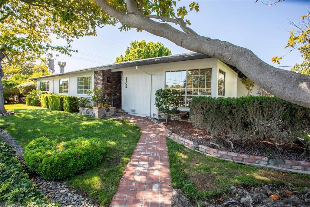 Walk in and be inspired! Comfort with a touch of nostalgia evoking feelings of warmth, familiarity, and sentimental value. Ideally located on a quiet, south-facing corner lot in a sought-after Santa Clara Killarney Farms neighborhood. The inviting home offers 3 bedrooms and 2 updated baths including the primary suite with private bathroom and large walk-in closet equipped with extensive built-ins. Features include reconditioned solid hardwood floors, recessed lighting, formal living and dining rooms, cheerful eat-in kitchen with Frigidaire stainless steel appliances, and ample storage. Adjacent to the kitchen is a separate family room with raised stone-faced fireplace flanked by built-in bookcases plus sliding glass door that opens to the new cement patio and yard. The well-maintained grounds are adorned with fresh grass, Japanese maple, mature lemon tree, flowers, rose bushes, and lovely protected magnolia trees. Recent improvements include new exterior paint, new 200-amp electrical panel, and Epoxy flooring in the attached 2-car garage. The property is conveniently located near restaurants, shopping, and tech companies, and offers easy access to Lawrence and San Tomas Expressways and Highway 101 putting the rest of the Bay Area within convenient reach.