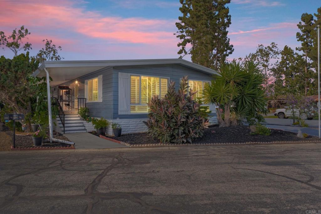 If you think you have seen Rancho Carlsbad, you have NOT!! This lovingly restored beauty (2023 to 2025) mostly all updated & remodeled home from sub floor to roof, plus everything in between is the gem of the neighborhood!!! Absolute premium lot location inside the park, end unit, close to clubhouse and breathtaking serene views. This 55 + Community is San Diego North County’s most sought after active-adult resort community offering true coastal living. You OWN THE LAND, no lot fees, 24 hour security, endless first class amenities. Home features were thoughtfully added, ADA compliant, 1/2 bath added for modern day needs. New roof, new dual pane windows, new AC. new tankless water heater, new deck, new subflooring, new shutters, extra sink in the kitchen, open & stunning kitchen with island. More outside storage than most with 2 (grandfathered in) spacious sheds. Low maintenance, thriving lemon, tangerine and orange trees surrounded by a lush, thoughtful yard. THIS will go fast- priced to sell-easy to show. CALL today for an appointment. Open house Sat July 26 from 11-1 pm. Amenities include a golf course and driving range within walking distance, clubhouse with ballroom, pickleball and tennis courts, resort-style pool area, RV storage, dog park, shuffleboard, bocce ball, expansive library, art room, fitness center, and countless clubs and activities. For gardeners- plot gardens for those who wish to grow veggies.