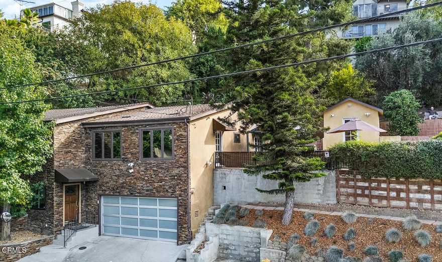 Beautiful hillside gem on over a quarter of an acre in Mount Washington. 3 bedrooms and 3 bathrooms, plus a bonus room comprise 2,758 square feet of living space with sweeping views and gorgeous terraced grounds. Lovely sunroom and a true cook's kitchen make this spot an oasis for entertaining. Finished 2 car garage and generous family room with full bath on the bottom floor creates flexibility for family and guests. Mature pine trees offer privacy and mature fruit trees include: pomegranate, lemon, lime, and loquat. An additional studio building can be storage, office, workout space, you name it.