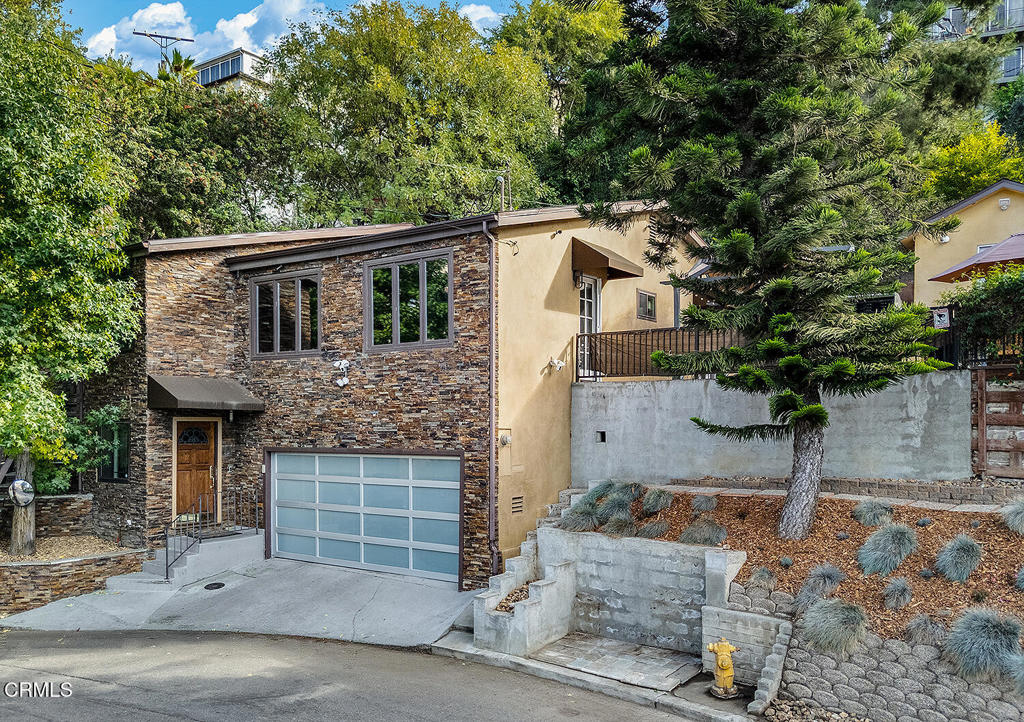 Beautiful hillside gem on over a quarter of an acre in Mount Washington. 3 bedrooms and 3 bathrooms, plus a bonus room comprise 2,758 square feet of living space with sweeping views and gorgeous terraced grounds. Lovely sunroom and a true cook's kitchen make this spot an oasis for entertaining. Finished 2 car garage and generous family room with full bath on the bottom floor creates flexibility for family and guests. Mature pine trees offer privacy and mature fruit trees include: pomegranate, lemon, lime, and loquat. An additional studio building can be storage, office, workout space, you name it.