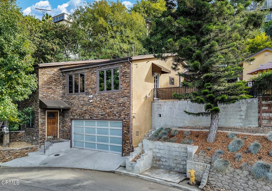 Beautiful hillside gem on over a quarter of an acre in Mount Washington. 3 bedrooms and 3 bathrooms, plus a bonus room comprise 2,758 square feet of living space with sweeping views and gorgeous terraced grounds. Lovely sunroom and a true cook's kitchen make this spot an oasis for entertaining. Finished 2 car garage and generous family room with full bath on the bottom floor creates flexibility for family and guests. Mature pine trees offer privacy and mature fruit trees include: pomegranate, lemon, lime, and loquat. An additional studio building can be storage, office, workout space, you name it.