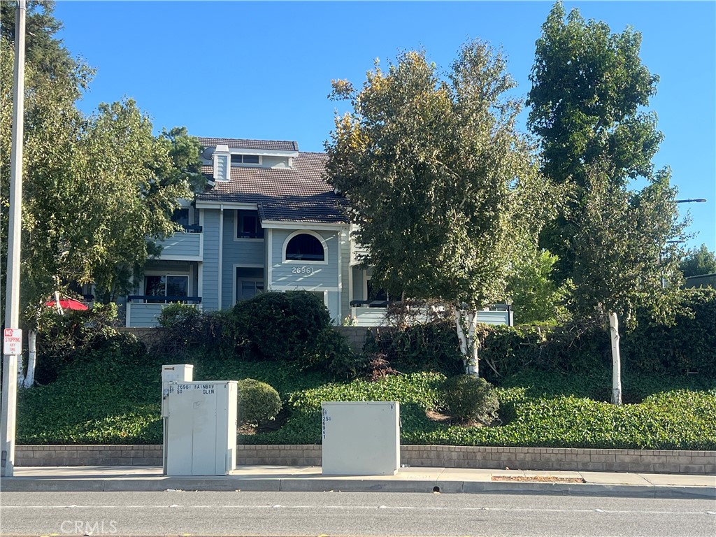 Great opportunity to own this beautiful condominium in Canyon Country! This American Beauty Community unit is located close to shopping, transportation and FWY. Home offers two bedrooms (primary bedroom with walk-in closet), two bathrooms, bright and cozy kitchen with granite counter tops, dining area, living room with fireplace and sliding doors leading to private balcony where you can enjoy the beautiful views! The laminate floors (living room & bedrooms) and tile floors (kitchen & bathrooms) are very nicely kept up, and the laundry area in unit (stackable) provides even more comfort. Building is adjacent to tennis courts, gazebo, picnic areas and one of the community pools. The 2 car tandem garage is steps away from your front door. Look at those views!