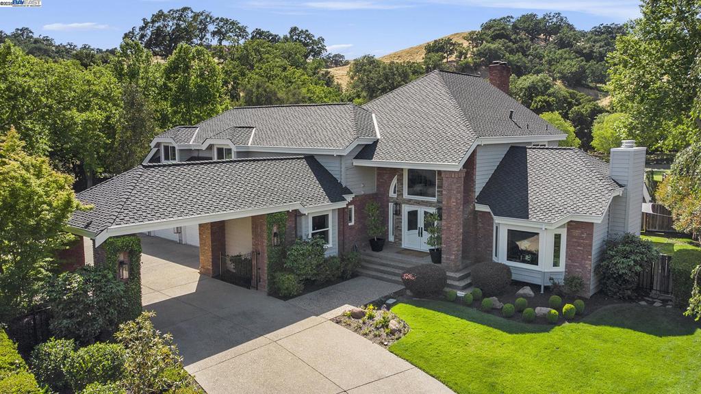 Dream home! Court setting inside the main gate at Blackhawk CC. w/ golf course views, backing to the 8th fairway green and 9th hole at the Lakeside Golf Course. Stunning curb appeal w/a brand new high end roof system & an elegant Port Cochere feature at the grand entrance w/ a long driveway. The kitchen family room combo is a knockout, featuring high end finishes & professional grade appliances. Generous Bar area w/ beer keg & refridgerator, bar seating and more. 4 bedrooms, (5th room used as an office, no formal closet & fireplace). All bedrooms are ensuites. 1 full bedroom suite and executive office is located on the street level. The second floor primary suite offers dual closets and a formal walk-in dressing room, sitting or work out area, dual vanity, soaking tub and more. The secondary en suites are spacious & updated. The backyard oasis features immense privacy, an impressive waterfall feature extending into a refinished swimming pool/spa. It offers built in BBQ, outdoor kitchen, sizable stone fireplace, gated dog run & more! Pie shaped .34 lot offers multiple sitting/entertaining areas. Easy to care for artificial lawns, captivating gardens, fruit trees, shrubs & flowering plants. Enjoy endless opportunities to relax, unwind or entertain! Truly a special property. Hurry!