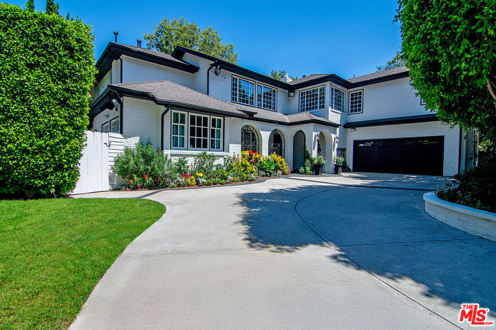 Gated and exquisitely remodeled estate compound in highly coveted Sherman Oaks. This elegant 5 BD + 5 BA Traditional style home boasts close to 6000 sf of living space and offers tremendous volume and superior finishes. Located south of the Blvd on an expansive 12,050+ sf lot complete with pool, waterfall, built-in BBQ, grassy play area, cabana, and large detached office offering excellent ADU potential. Stately double door entry leads to dramatic 2-story ceilings with sun-drenched open floor plan, picturesque windows, and grand sweeping staircase. Interior features include a sizable gym, movie theater, wine room, office, and generous upstairs family room. Other amenities include beautiful French doors, gorgeous wide-plank wood floors, immaculate chef's kitchen with top-of-the line appliances, spacious primary suite with sitting room and fireplace overlooking backyard, luxurious primary bath, and enormous custom-built walk-in-closet. Fantastic family home with all the bells and whistles. Located close to shopping, restaurants, top schools, and everything Sherman Oaks has to offer!
