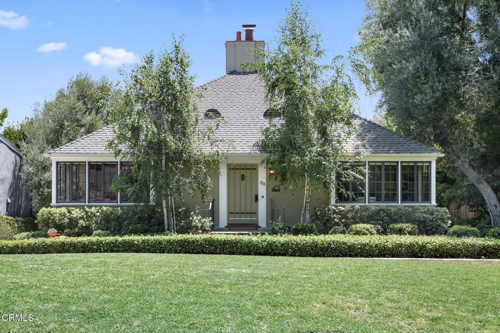 Set on a peaceful side street in Pasadena's prized Oak Knoll neighborhood, 818 Huntington Garden Dr welcomes you with picture-perfect curb appeal and storybook charm. As you enter, a world of thoughtful design and craftsmanship reveals itself. Hardwood floors, elegant crown moldings, white oak accents, and walls of windows create a setting that feels both refined and inviting. Host dear friends in the radiant living room, where the fireplace sets a warm, inviting tone during the winter months and sunlight pours in year-round. Nearby, the dining room offers peaceful front yard views and easy access to the bright and tidy kitchen. Privately tucked in the rear for added privacy, the primary suite features generous closet space, an ensuite bath with updated shower, and a spacious balcony. A sunny secondary bedroom nearby also includes its own ensuite. Downstairs rests the spacious family room complete with a second fireplace and French doors opening to the backyard. This versatile space can easily serve as a creative studio or home office. Completing the lower level, find a laundry room and full bathroom. In the peaceful backyard, a stone patio and grassy lawn are shaded beneath a canopy of branches, and lush layers of foliage wrap the space in peaceful seclusion. For added convenience, a fully permitted junior ADU adjoins the detached 2 car garage. With Lacy Park, Garfield Park, San Marino's Mission District shops, and The Langham all within one mile, 818 Huntington Garden Dr is a special home to cherish for years.