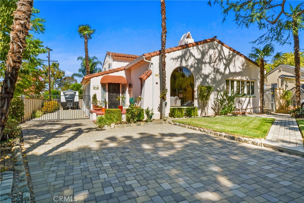 A Rare Spanish Revival Gem on Iconic Euclid Avenue...Step into timeless elegance with this 1937 Spanish-style masterpiece, perfectly perched along Upland’s most iconic tree-lined street. Bursting with original character, this historic home features soaring gabled ceilings, a grand arched picture window, rich hardwood floors, and rare attic and basement spaces—each detail telling a story of craftsmanship and charm. This 3-bedroom home includes a downstairs bedroom and full bath, plus a dedicated office—perfect for working from home or creative space, and 2 additional bedrooms upstairs. The curb appeal is unmatched, with manicured landscaping and updated paver walkways leading to a private backyard behind wrought iron gates offering an attached garage and generous RV parking. Homes like this rarely come available—especially in such a prime location with mountain views and timeless architectural beauty. Whether you’re a lover of historic homes, a visionary with taste, or someone who’s been patiently waiting for a truly special property to call home—this is your moment.