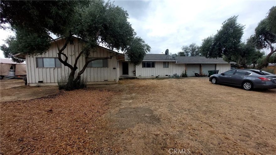 Diamond in the Rough with Huge Potential! 4 Bedrooms,  2 Bathrooms Ranch Style home on 1.19 Acres!  Located on the peaceful North edge of Corning, this 1966-built home sits on a spacious 1.19-acre lot and offers an incredible opportunity for investors, flippers, or DIY buyers looking to build equity.  Featuring 1,700 sq. ft. of living space, the home includes 4 bedrooms, 2 bathrooms, and a large living room with a cozy fireplace. The floor plan offers a solid foundation for updating and customization.  A 2-car attached garage with a dedicated shop area provides extra space for projects or storage.  The property is connected to City of Corning water and has an existing septic system.  Heating is provided by central natural gas furnace, air conditioning may or may not work and needs tested.  The roof, an architectural-style composition shingle, was replaced in May 2015.  Out back, you'll find a small olive grove—overgrown but offering excellent potential as a natural privacy screen and windbreak. The home and yard are in need of renovation, making this an ideal candidate for a flip or a homeowner with vision and willingness to invest in improvements.  A Cash sale is preferred due to the current condition of the property, which may not qualify for financing. Don’t miss this chance to unlock the potential of this hidden gem. Call today to schedule your private showing!