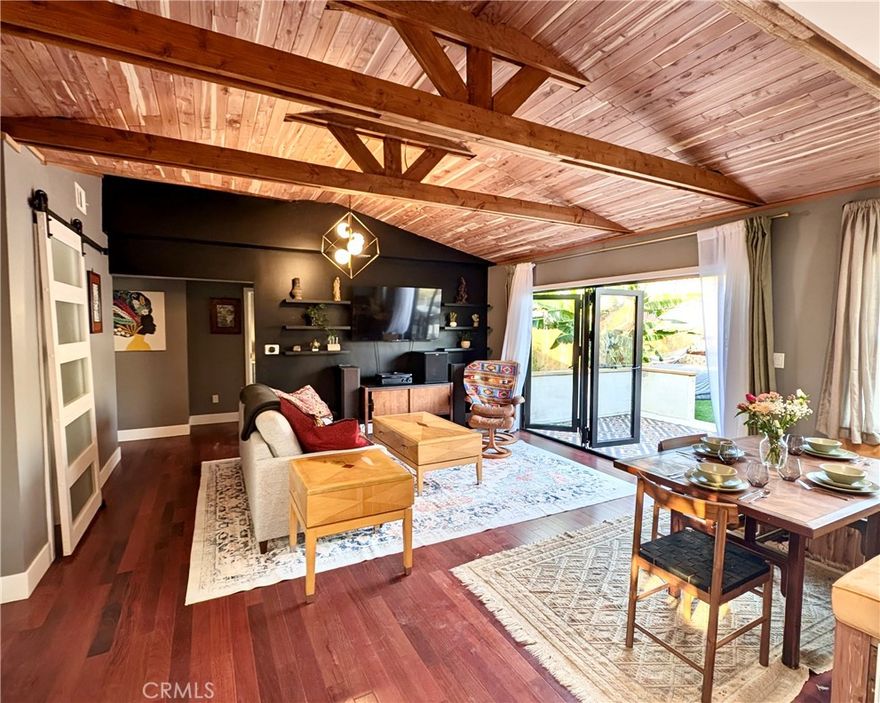 Freshly renovated and thoughtfully designed, this light-filled and versatile home is currently configured as two separate dwellings, offering exceptional flexibility for multi-generational living, rental income, or a seamless return to a generous three-bedroom home. The main residence comprises 2 bedrooms and 1.5 bathrooms, complemented by a separate, fully self-contained 1 bedroom, 1 bathroom apartment and a detached 2-car garage.
The main home is stylish and welcoming, featuring rich 3/4 inch Brazilian Cherry hardwood flooring and custom built-in shelving throughout. The upgraded kitchen is both elegant and highly functional, showcasing premium Wolf appliances including a gas cooktop and a five-in-one multifunction speed oven, Brazilian marble waterfall benchtops, real wood cabinetry, and a Bosch dishwasher. The living area is bathed in natural light and opens effortlessly to a spacious patio through a four-panel folding door, creating a true indoor-outdoor lifestyle. The full bathroom includes a bathtub and separate shower, while an intelligently designed laundry and powder room adds convenience.
Outdoors, the backyard is a tranquil retreat. Terraced for privacy and usability, it features a drought-resistant garden and an impressive selection of mature fruit trees including lemon, orange, pomegranate, and vanilla ice cream bean.
The front unit offers one bedroom and one bathroom. Previously operated as a registered short-term rental, it is beautifully appointed with granite countertops, Brazilian cherry flooring, split-system heating and air conditioning, and a tiled walk-in shower. A fenced front patio with flagstone hardscape enhances privacy. The unit is lightly furnished and rental-ready.
Significant recent improvements add immense peace of mind and long-term value, including updated plumbing and electrical, full sewer line replacement, a new roof, and a newly installed owned solar system. The home features interior Rockwool sound-insulated walls and excess roof insulation ensure maximum privacy and energy efficiency. This is a stylish, intelligently upgraded property that offers flexibility and quality in equal measure, ideal for owner-occupiers or investors seeking adaptable living without compromise.