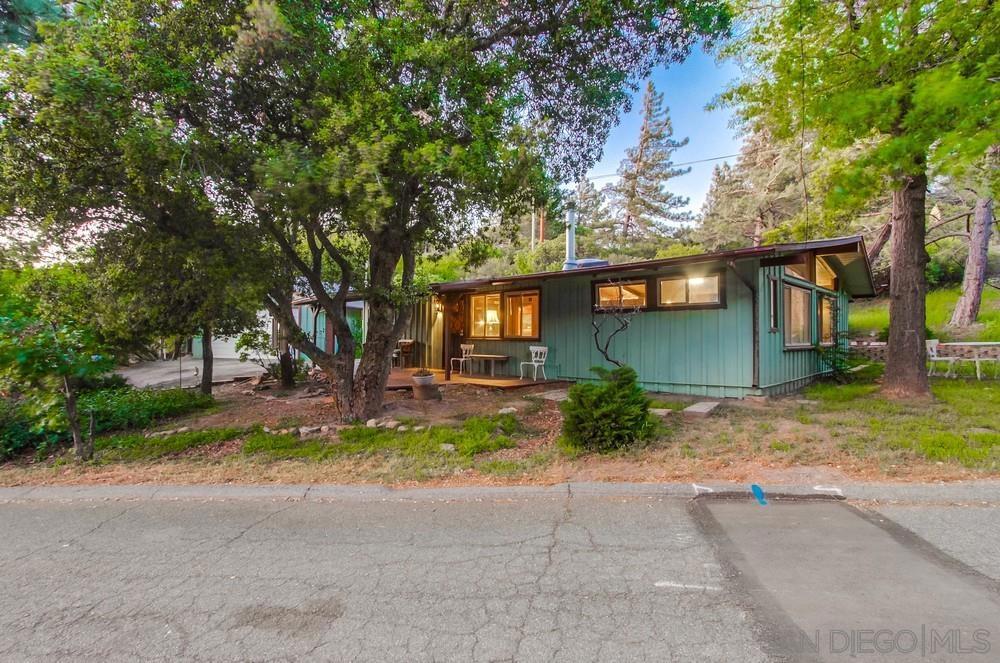 Charming home on a quiet street in the heart of Julian. This private, tucked away retreat offers a chance to enjoy all that life in the mountains has to offer. The home rests on just under 1/4 of an acre, and boasts 2 spacious bedrooms, a large living area that opens to the kitchen, and a dining space overlooking the beautiful outdoors. The custom windows throughout bring in tons of natural light and the vaulted ceilings create a sense of openness, while preserving the cozy-cabin feel. The home is perfect for a small family, or could be used as a vacation home getaway and the detached 2-car garage offers space for storage and parking. Pride of ownership abounds with updated flooring, fresh exterior paint, and dual pane windows. The front patio is the perfect spot to enjoy a morning cup of coffee or an evening outside watching the sunset. Hurry, this one won't last long! Kentwood in the Pines is only 5 minutes from downtown Julian, which is known for its historic charm, apple orchards, and stunning mountain scenery. Julian offers a peaceful retreat just an hour from the hustle and bustle of San Diego.