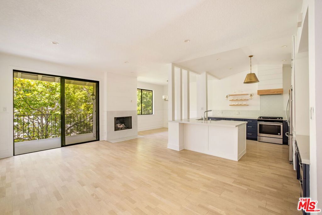 Just moments from the sand and the chic boutiques and cafes of Montana Avenue, this fully remodeled residence blends elevated design with a relaxed, coastal sensibility in one of Santa Monica's most coveted neighborhoods. Bathed in natural light and defined by soaring ceilings, the open-plan layout flows effortlessly from the formal entryway to the living room with a cozy gas fireplace and access to a spacious covered balcony with lush treetop views. The dining area connects to a show-stopping kitchen appointed with quartz countertops, premium stainless steel appliances, custom cabinetry with ample pantry space, and designer finishes that balance style with everyday function. The generous primary suite is a true retreat, featuring high ceilings, dual closets, balcony access, and a spa-inspired bathroom with a soaking tub, glass-enclosed shower, dual vanity, and exquisite custom tilework. A secondary bedroom with its own balcony and walk-in closet offers flexibility for guests or a home office. Additional highlights include a built-in workstation, in-unit washer/dryer, designer lighting, and bespoke millwork throughout. Set within a charming, well-maintained community, residents enjoy controlled access, secure side-by-side parking for two vehicles, guest parking, and resort-style amenities including a sparkling pool and spa surrounded by lush landscaping. The result is a rare lease opportunity where modern elegance meets the best of Santa Monica coastal living.