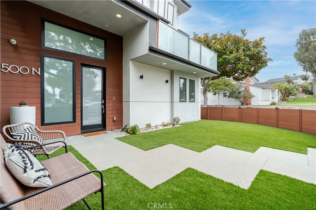 Modern coastal elegance meets everyday comfort at 500 N Lucia Ave. Built in 2017, this corner detached townhome lives like a single-family residence, offering four bedrooms, five bathrooms, and approximately 2,800 sq ft of thoughtfully designed living space just blocks from the beach.
From the moment you enter, soaring 16 foot ceilings and expansive windows fill the home with natural light, creating a dramatic yet inviting atmosphere. The upgraded gourmet kitchen is a true showpiece, featuring a professional-grade Viking range and dishwasher, Sub-Zero refrigeration, granite island and countertops, custom cabinetry with wine storage and bar, and bespoke wine storage; a layout crafted for both everyday living and effortless entertaining.
Refined details continue throughout the residence with hardwood floors, upgraded chandeliers, and an elegant fireplace. A Control4 smart system, wired speakers, and water softener add modern convenience, while financed solar and newer central AC ensure efficiency year-round.
The primary suite boasts custom cabinetry, an organized walk-in closet, and a spa-inspired bath with imported fixtures. Each bedroom includes a custom closet and en-suite bath, with three of the five bathrooms having been nearly never used. A versatile loft with custom storage, private laundry room, and two view decks further enhance livability.
Additional upgrades include a full-service elevator, central vacuum system, newer turf in the private yard, and an oversized two-car garage.
Perfectly situated, 500 N Lucia is just steps from Beryl Heights Elementary, Parras Middle School, and Redondo Union High, with Redondo Beach Harbor and PCH close by for dining and shopping. Whole Foods, Jus’ Poke, The Boy & The Bear Coffee, and a myriad of local gems are right around the corner — placing the very best of the South Bay at your doorstep.