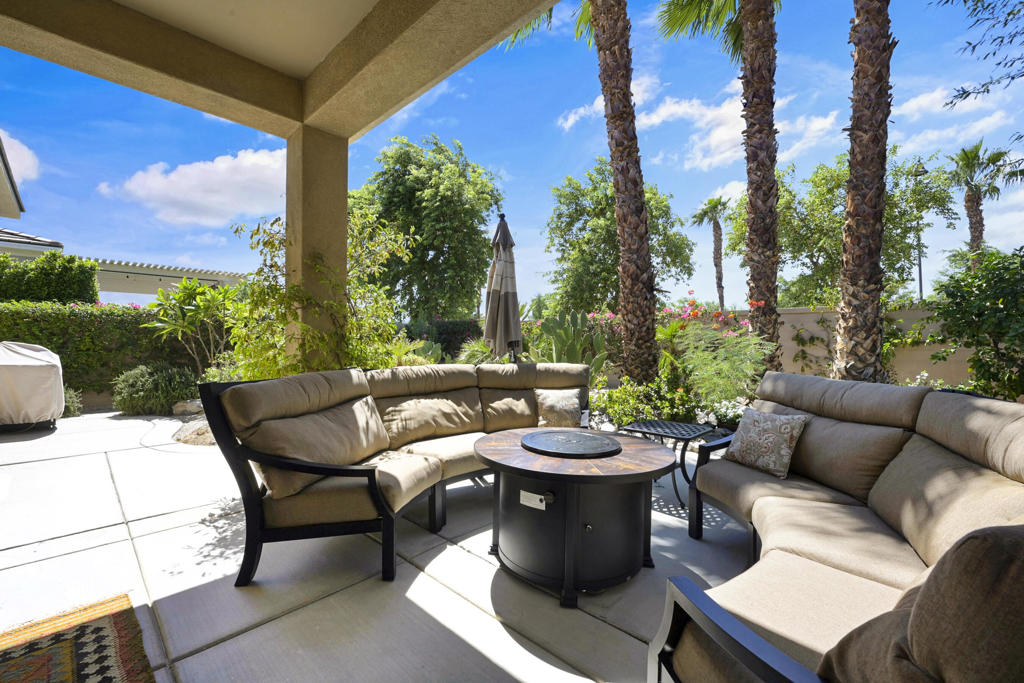 Ownership shines in this meticulously maintained Hideaway floor plan offering 1,512 square feet (EST.) of comfortable living space in the desirable 55+ active adult community of Sun City Shadow Hills. Featuring two bedrooms, two bathrooms, and a versatile den/office, this home blends functionality with modern style. The heart of the home is the open-concept great room and kitchen, perfect for entertaining. Enjoy a kitchen that showcases rich wood cabinetry, granite countertops, stainless steel appliances, pendant lighting, and a spacious center island with bar seating. The dining area flows seamlessly into the living room, where large sliding glass doors allow an abundance of natural light from the southern exposure open to the private backyard. Relax in the primary suite offering a relaxing retreat with a spa-inspired bath featuring dual vanities, a walk-in shower, and a generous walk-in closet. Additional highlights include, ivory tile flooring throughout, plantation shutters, ceiling fans, a laundry room with built-in cabinetry, and a two-car garage with epoxy flooring and overhead storage. Step outside to your own desert oasis. The backyard is lush and meticulously maintained with mature palms, cactus, and flowering plants, creating a serene sanctuary. A covered patio allows for seating and a fire pit lounge area a perfect space for outdoor living year-round. Residents of Sun City Shadow Hills enjoy premier amenities including two golf courses, two clubhouses, fitness centers, pools, tennis and pickleball courts, and countless social activities. Don't miss out on this incredible home!