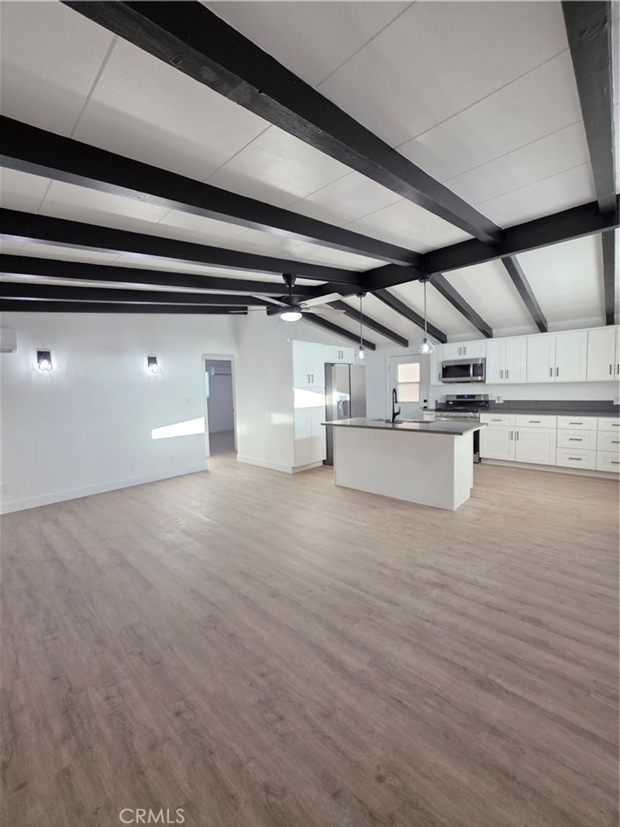 Welcome to this beautifully remodeled 4-bedroom, 2-bathroom home offering modern living in the heart of San Fernando. The property features a brand-new two-bedroom, one-bathroom addition, making it ideal for extended families or flexible living arrangements. Everything has been upgraded, including new plumbing, electrical, flooring, fresh paint, new light fixtures, new tile, and fully remodeled bathrooms with sleek modern showers. The kitchen has been updated with contemporary finishes and new appliances, while the living room showcases vaulted ceilings with exposed beams for a bright, open feel. Enjoy year-round comfort with a new AC and heating system and the efficiency of a tankless water heater. The home also offers generous parking for up to six vehicles. Conveniently located near schools, shopping, and major freeways, this home delivers both comfort and accessibility. This is a truly move-in-ready property where everything feels brand new.