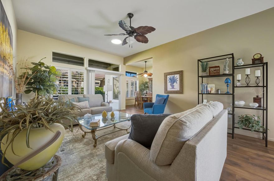 Sun City Palm Desert - Topaz. This beautifully appointed home is located in one of Sun City's most desirable neighborhoods, where the HOA maintains the common-area landscaping, stucco, and roof for truly carefree living. Ideally situated just a short distance from both the Mountain View and Sunset View Clubhouses, the property enjoys easy access to the community's premier amenities. Set along a lush greenbelt, the home's north-facing rear patio offers a tranquil space for relaxing or entertaining while enjoying the natural surroundings. The gated, south-facing front courtyard enhances curb appeal with additional patio space and low-maintenance artificial turf. Inside, the home features tile and luxury vinyl plank flooring throughout, complemented by plantation shutters, transom windows, and Solatubes that fill the space with natural light. The kitchen boasts granite countertops, a breakfast bar with pendant lighting, and upgraded sink and fixtures. The primary suite includes a charming bay window, a walk-in closet with built-in storage, and mirrored wardrobe doors. Its en-suite bathroom offers a granite-topped vanity with upgraded dual sinks and fixtures, along with a stall shower framed by a glass enclosure. The guest bathroom features a tub/shower combination and an upgraded vanity with granite counters. A spacious guest bedroom and a two-car garage with built-in storage complete this exceptional home.