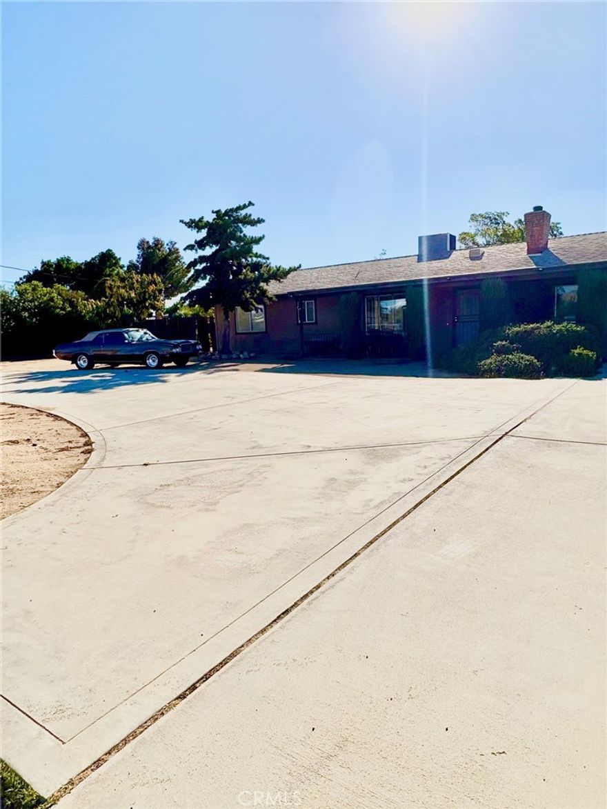 WOW this AFFORDABLE house sits on a 1.05 ACRE LOT! This humble abode has 2 big size bedrooms and 2 bathrooms plus an office that can be converted to another bedroom and an enclosed patio that can be a bonus room, another bedroom or a family room.  LOTS of POTENTIAL! Perfect for people looking to park their Semi Truck, store containers, build another house at the back as ADU or rental, or build own oasis with pool, or plant plenty of fruit trees and vegetables. Perfect for commuter because it is minutes away from the 15 freeway. Get this home now to set yourself once the bullet train going to Vegas start operating.  Features to notice: Roof is less than 3 years old, HVAC is just 4 years old, hot water heater is just a bit over 5 years old, tennis court at back, 4 shed storages, oversized car garage and a drive-through, ceiling fans, fireplace, laundry room with utility sink, circular driveway, evaporative cooler, dual sinks in masterbathroom, and low maintenance front yard. NO HOA & NO MELLO ROOS!