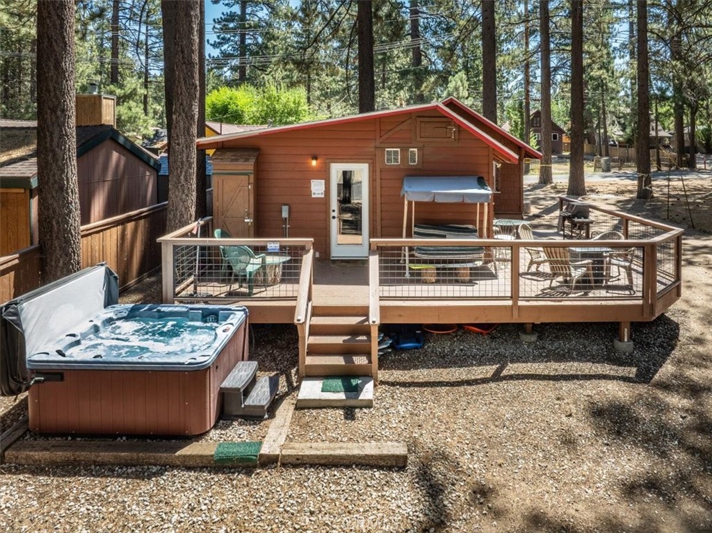 A fully renovated original Hunter’s Cabin that blends rustic charm with modern upgrades. Perfectly located just a short stroll to the lake and minutes from all Big Bear has to offer, this R-3 zoned property not only delivers a picture-perfect mountain escape, but also the potential to add another cabin. There’s ample space for a boat, RV, and all your adventure gear, making it as functional as it is charming. Inside, you’ll find a bright and inviting living space with laminate and tile flooring, wood blinds, a remodeled bathroom, and new ductless HVAC (mini-split) for year-round comfort. The upgraded kitchen features granite countertops, stainless steel appliances, and a gas connection ready for your stove. In addition to the main living area, there’s a versatile room with approximately 200 sqft of living space — perfect as a kids’ bunk room, guest quarters, or bonus lounge. The open layout flows to a wrap-around deck ideal for morning coffee, evening BBQs, and enjoying Big Bear’s crisp mountain air. Outdoor living is where this property truly shines. Relax in the newer Jacuzzi spa, gather around the gas firepit, or enjoy the privacy of a 150-foot redwood fence. Two oversized sheds provide generous storage, while included furnishings make this home completely turn-key. With proven vacation rental income potential and a location just an 11-minute walk to Santana Mavericks Bar & Grill, this cabin is ready to be your weekend retreat, full-time home, or investment opportunity.