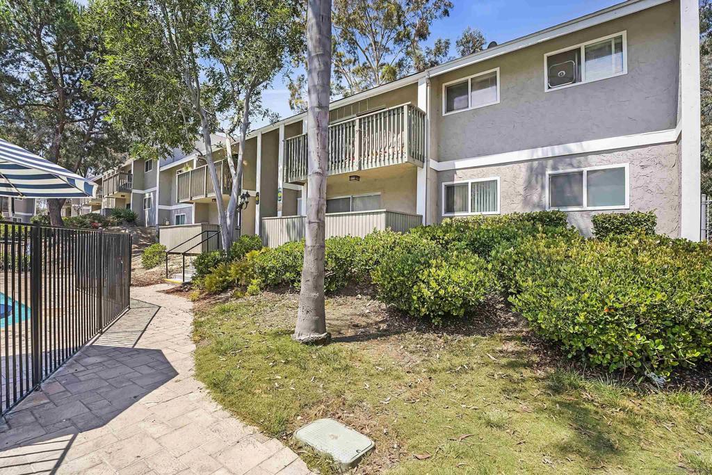 FHA & VA approved. Discover one of the most affordable 3-bedroom, 2-bathroom condos in San Diego County! This single-level, first-floor, END unit offers an unbeatable location within Lake Park Villas. It backs directly to open green space, providing serene views from the kitchen, dining area, and master suite. Plus, it's conveniently close to laundry facilities and community pool. The kitchen boasts granite slab countertops and beautiful cabinets. It's equipped with new stainless steel fridge and dishwasher. Features 3 bedrooms, with 1 master suite. Luxury Vinyl Plank flooring throughout The living room is bright and airy, with a sliding glass door that opens to a fenced front patio, extending your living space outdoors. A spacious storage closet in the living room extends under the exterior stairwell, providing ample storage. One assigned carport with option to obtain 2nd parking permit. HOA fees including water/hot water/trash/sewer/common area maintenance/limited insurance. Lake Park Villas offers a prime location within walking distance to shopping and restaurants, with easy freeway access and close proximity to San Diego State University and more
