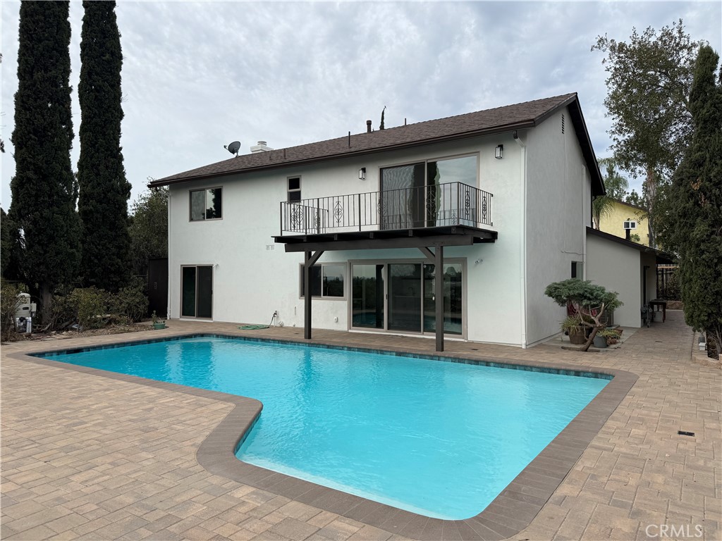 Perched above Chatsworth on a private 13,249 sq ft flag lot, this freshly renovated 4-bedroom, 2.5-bath home offers panoramic views of the San Fernando Valley. The 2,211 sq ft layout has been thoughtfully updated in 2025 with major system improvements including a new roof, HVAC, and a brand-new main sewer line to the city connection; interior renovations featuring a modern galley-style kitchen and updated bathrooms; exterior upgrades such as a new driveway and patio pavers; and outdoor enhancements including a resurfaced pool.
The entry level offers a welcoming living room with fireplace, a dining area, and a breakfast nook adjoining the galley-style kitchen with ample cabinet space. A convenient 3/4 bathroom serves the downstairs. Two sets of large sliding glass doors open to the private spacious backyard, where a resurfaced pool, new equipment, paver patios, and easterly views create an ideal setting for outdoor living and entertaining.
The primary bedroom includes a private patio with sweeping views, an ensuite bath with vanity, and dual closets. Three additional bedrooms share a full bathroom, providing comfortable accommodations for family or guests.
An attached garage, previously converted into a den, workshop, and laundry area, offers additional usable space but has not been part of the recent renovations—presenting flexibility for future customization.
With its elevated hillside setting, modern upgrades, and unique flag-lot privacy, this Chatsworth home blends comfort, functionality, and breathtaking views into one rare offering.