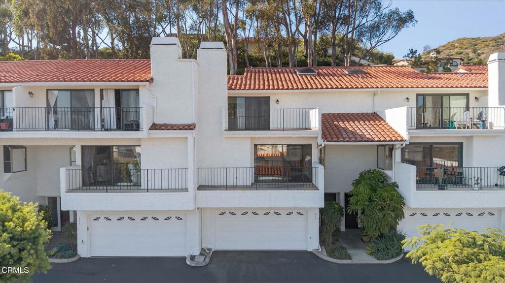 Nestled in the vallecitos of our Ventura hillside resides this Santorini like complex overlooking our ocean views, the island views, our downtown city lights, and the quiet lively hillsides full of nature. Beautiful and over-sized the floor plan welcomes the outside in. A delightfully unique floor plan has an ocean view balcony for the living room, a stoop for the kitchen, a patio full of eucalyptus for the guest primary suite, and a massive ocean view deck from the primary bedroom. I can imagine sleeping with sliders open, wind whistling off shore and the occasional sounds of large surf in the winter months or the lingering music late nights on the weekends. Neutral in palette this sweet home will accommodate your vision and allow for your things to be perfectly set. Enter formally and be greeted with a dramatic stairwell, newer berber carpets, black railings, and fresh paint. On the 2nd level you'll find your main living areas complete with a breakfast bar, fireplace, balcony, living room, dining room and 1/2 bathroom. The third floor holds two bedrooms, the primary is huge and awaiting your design and has his and hers bathrooms, lots of closet space, and a massive ocean view deck. The 2nd primary has a walk-in closet, on suite bathroom, and a quiet patio under the trees. It feels good here. The garage is plenty with lots of options for you to consider. In addition to everything else wonderful is a community pool, spa, and clubhouse for you to enjoy. What are you waiting for?