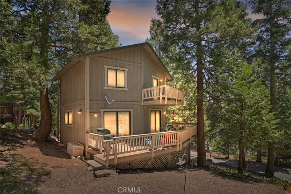 Your cabin in the mountains just showed up!!! Quiet shady setting close to the little town of Twin Peaks. Warm and welcoming. One big fun living area so you don't have to miss out if your family or friends are working a puzzle by the wood burning fireplace or watching your fave TV show. Serve up the guests on the outside deck and enjoy nature. Pop in a load of laundry, it's conveniently located just off the living area. Guest bath on main level. 2 nice sized bedrooms upstairs and a full bath. Beautiful wood flooring adds charm and character. The natural pine tongue & groove add to the mountain ambiance. One upstairs bedroom has a balcony. Covered front porch. Build-up area accessible and offers some good storage. Up slope with off-street parking for several cars.