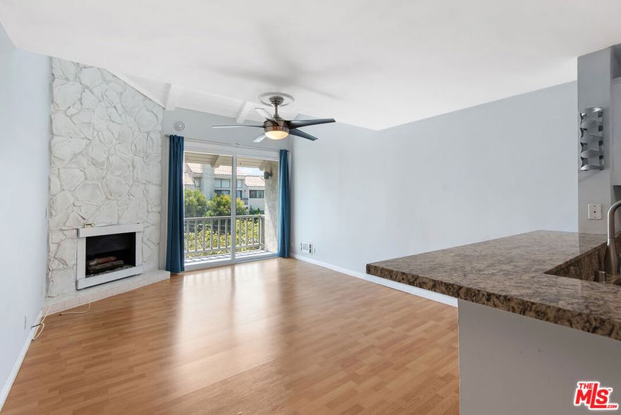Beautifully updated top-floor 1-bedroom, 1-bathroom front facing unit at Del Rey Plaza. This spacious, light-filled home features wood floors and a generously sized living room with vaulted shiplap ceilings, a cozy fireplace, and sliding glass doors that open to a private balcony offering treetop views. The updated kitchen includes granite countertops, stainless steel appliances, ample cabinetry, a breakfast bar, and adjacent dining area with extra storage. The well sized bedroom offers high ceilings and ample closet space. Unit also comes with one parking space. Building amenities include a pool and community laundry on every floor. Conveniently located near shopping, schools, beaches, restaurants, bars, and a scenic bike path.