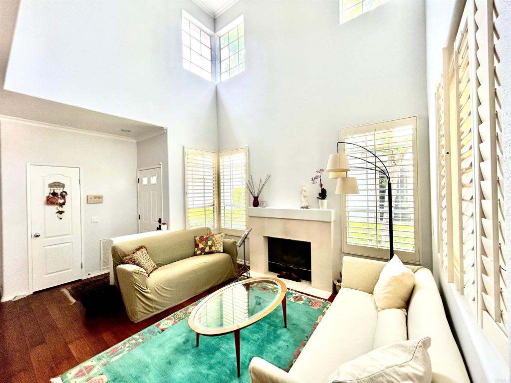 Picture a modern and beautiful townhome with a private backyard and a nice View! The first floor opens into a spacious living area with high ceiling and a fireplace and a dining room. The open concept kitchen has white cabinets and granite countertop with a window to enjoy the view while cooking. House features downstairs hardwood floor and white clean carpet upstairs. There is a loft upstairs that can be used as an office or a play area for kids. Plantation shutters at the master bedroom and downstairs. Attached 2 car garage and convenient location to all! A must see!