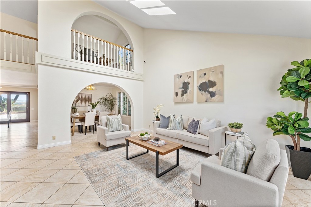 Set in the heart of Mission Viejo, this beautifully updated home combines refined style with relaxed California living. With 2,766 square feet of living space, panoramic views, and a private backyard retreat, this 4 bedroom, 2.5-bath residence offers the perfect setting for everyday comfort and weekend entertaining. Step inside to find an open-concept layout filled with natural light. The bright, expansive kitchen has been remodeled with high-end appliances, custom cabinetry, and sleek countertops, ideal for everything from casual breakfasts to dinner parties. Just off the kitchen, the spacious family room is designed for connection and entertainment, complete with a built-in surround sound system and projector screen for your favorite movies or game day gatherings. Upstairs, the primary suite offers a peaceful retreat with a spa-inspired bathroom, generous sized walk-in closet, and private deck with sweeping views. You will also find 3 additional rooms upstairs (one room was used as a loft/office but could easily be converted back to a room). Step outside to your private backyard escape, where a sparkling pool, panoramic views, and a built-in bar and grill area create the ultimate setting to unwind or host guests. A three-car garage offers plenty of room for vehicles, hobbies, and extra storage. Located in one of Mission Viejo’s most desirable neighborhoods, this home is a rare blend of comfort, design, and lifestyle.