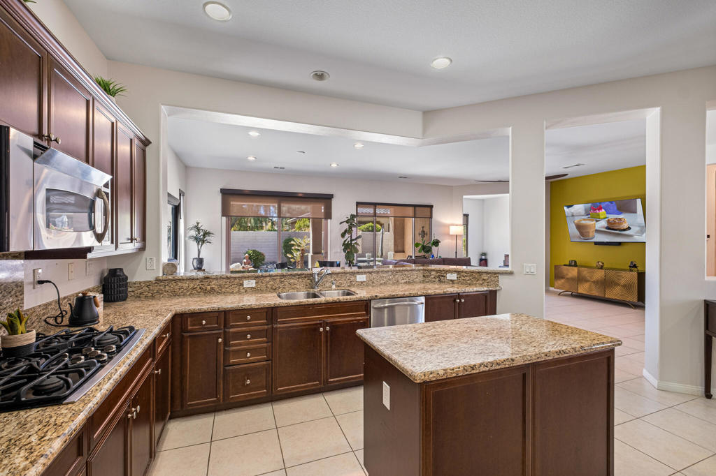 The perfect blend of comfort, privacy, functionality and entertainment. A truly great Sorrano model with 2 bd and 2 baths and Office/Den plus....a separate guest Casita with own bath - making it unique 3bd/3bd combination. Wait !....owned Solar and brand new A/C. A private courtyard provides additional own space between main house and the Casita. The split floorplan ensures privacy and comfort, while the kitchen oversees the main activities. The spacious L-shaped kitchen with stylish granite counters compliments the Chef's Island and the caramel color cabinets. You have a wonderfully-sized separate breakfast area blended with the kitchen, while the split two tiered counters connect to the formal dining area. Step into your own 'world' and the secluded main bedroom - private and very spacious. Further comfort is evident - main bath features separate shower, tub with exotic touches and dual sinks. A good size second bedroom located in the opposite wing of the house with 'own' bath next to it. The separate guest Casita with own bath is a priceless addition. A much desired South-West exposed backyard offers large shaded covered patio and wonderfully-landscaped environment. Located in the Sun City Shadow Hills, a very active 55+ community offering everything from fitness, pool, restaurants, various courts and activity rooms.
