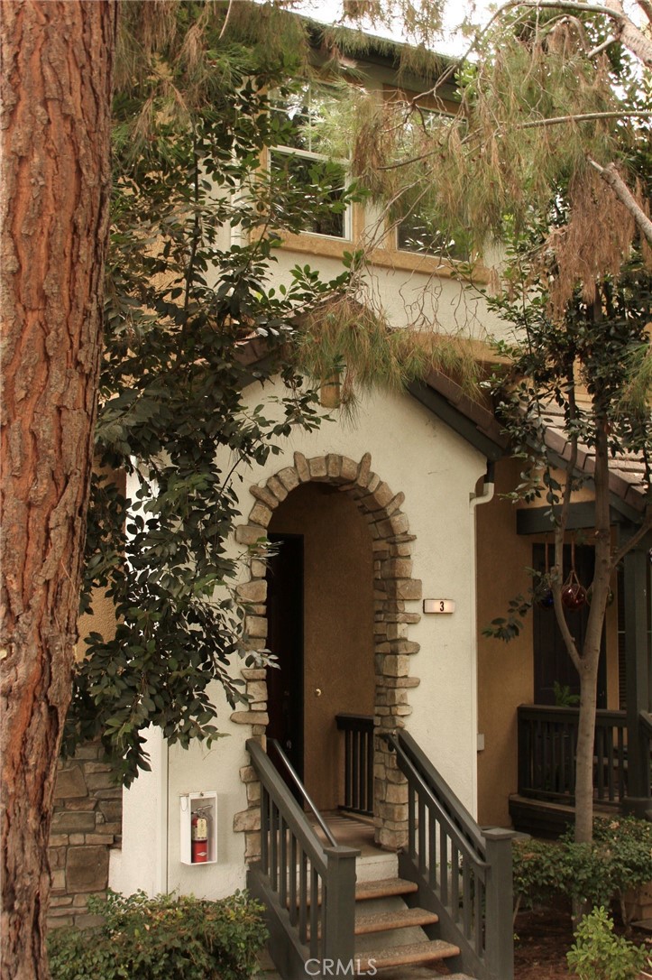 Very charming three bedroom townhouse, 2.5 baths and two car attached garage townhouse, lots of trees all around. You enter into the living room with very high vaulted ceilings, and decor fireplace. Next level is the dining room, kitchen and nook area with balcony and 1/2 bath near. Direct entrance to a two car garage and 3rd level are the bedrooms and bathrooms. Newly painted, new stove, newer blinds. newer carpet on stairs and new carpet in bedrooms, beautiful vinyl flooring in living room stairs and dining area, high vaulted ceilings. Property is within walking distance to multiple parks, including hiking trails extending to Laguna Beach. Picturesque park with panoramic views of the Saddleback mountains, easy promenade to the nearby town center with a theatre, shopping and many restaurants. Good location if you have kids, near schools. Association pool and spa are near property.