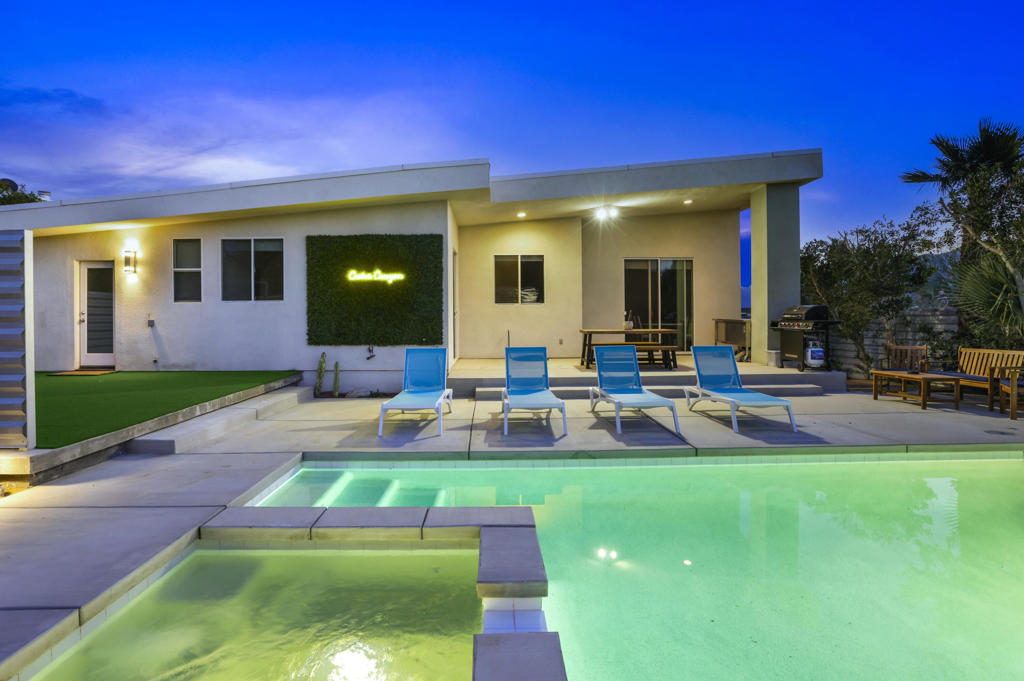 Welcome to this stunning 3-bedroom, 2.5-bath home nestled in the highly sought-after Historic B Bar H Ranch Neighborhood. This residence artfully combines contemporary design with authentic desert charm, creating a perfect blend of style, comfort, and functionality.As you step inside, you'll be greeted by an open-concept living area featuring soaring ceilings, a cozy fireplace, and abundant natural light. The spacious kitchen boasts rich cabinetry, stainless steel appliances, and a large center island with seating--ideal for both entertaining and everyday family life. The adjoining dining area opens directly to the backyard oasis through sleek sliding glass doors.The primary suite serves as a private retreat, complete with an en-suite bath featuring dual sinks, a separate tub, and shower. Two additional bedrooms share a full Jack & Jill bathroom, offering flexibility for accommodating guests, family, or setting up a home office.Step outside to your personal resort-style getaway, featuring a new pool, spa, and patio completed in 2022. This outdoor space is fully enclosed by a striking corrugated metal fence, ensuring privacy and adding a modern edge. Multiple lounge areas, a dining patio with a BBQ setup, and meticulously designed desert landscaping make this yard ideal for relaxation and entertaining.Recent upgrades enhance the home's value and functionality, including a HVAC unit that is only 4 years old, with the compressor replaced in mid-2025. A state-of-the-art water purification system was added in 2025 to eliminate hard water, benefiting both the home and the pool. Plumbing upgrades and new toilets were also installed in 2025. For your convenience, push-button pool automation was added in 2023, allowing you to control the pool and spa from your phone or tablet.Additional highlights include an EV charging system and stylish modern finishes throughout the home.Conveniently located just minutes from Palm Springs and Desert Hot Springs, this home provides easy access to shopping, dining, golf, and outdoor adventures. Whether you're seeking a great short-term rental opportunity, a delightful full-time residence, or a seasonal retreat, this property offers versatile possibilities to suit your lifestyle.