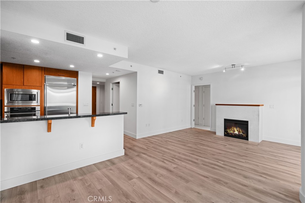 *Lease includes water, gas, trash and internet* - Welcome to elevated city living in this beautifully appointed 13th-floor unit, where contemporary design meets comfort and convenience. This spacious unit offers an open-concept layout with natural light. Capture a beautiful sunrise with one of the largest balconies sitting in Orange County's most prestigious high-rises and then right after go for a nice stroll around park place. This unit has one of the most desirable layouts in the building, with two large bedrooms with dual access to the balcony to enjoy both city lights and siren views of The Park. This unit also includes a home office/den making it perfect for a remote office from the luxury of your own home. Enjoy brand-new high grade scratch and waterproof laminate flooring, and brand new highly graded carpet. This 24-hour guard gated community offers: a heated pool & spa, billiards room, gym, theater, lounge. Walking distance to convenient Park Place Amenties, Fine Dining Restaurants and EV Stations. Minutes away from Fashion Island, South Coast Plaza, John Wayne, and Orange County beautiful beaches