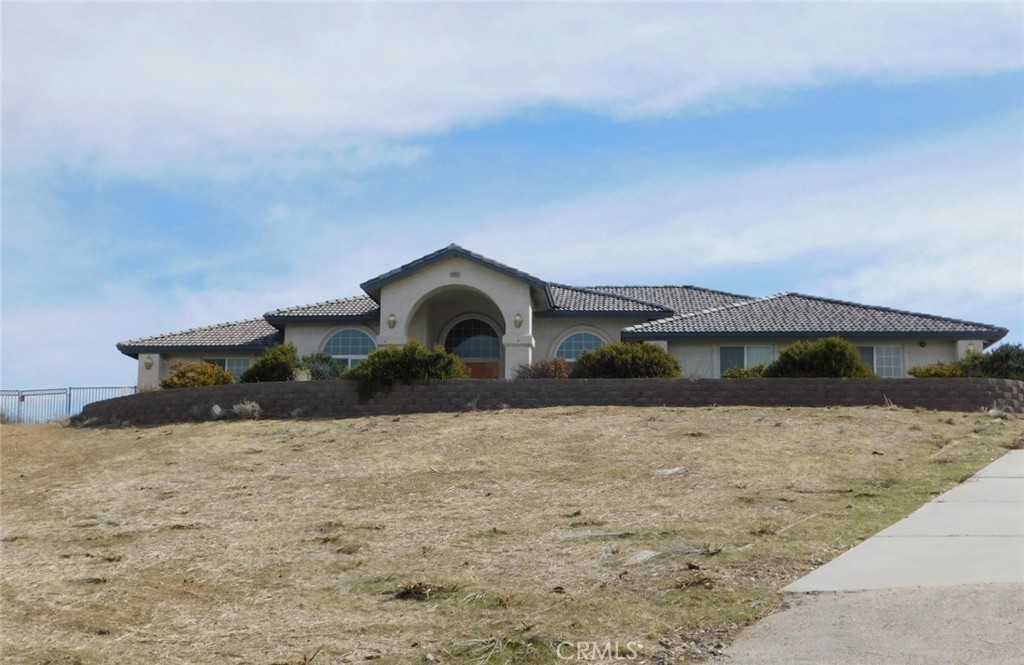 Come take a look at this fantastic property. This home has plenty of space. Interior features 3 bedrooms 2.5 baths. The front entrance has 2 sided living areas,formal dining and living room. This kitchen opens into the living quarters with a fireplace. Secondary bedrooms with plenty of closet space. The main bedroom suite is oversized with another fireplace, walk into the ensuite bathroom to dual sinks, soaking tub and separate shower and the walk in closet. There is an office and indoor laundry room. The exterior has a large sunken patio with BBQ. 2.46 acre lot with drive through access to rear gate for entering in and out. 3 car attached garage.