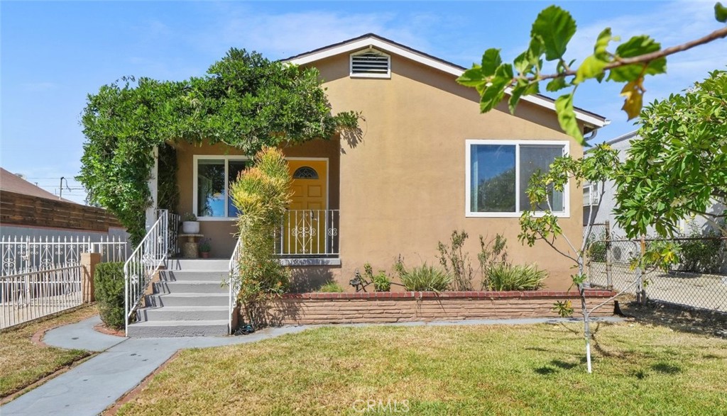 Perched above the street with a fully fenced yard, this Boyle Heights charmer blends comfort, character, and modern updates. A wisteria-draped front porch sets the tone, welcoming you into a freshly painted interior with real hardwood floors, new carpet, and dual-pane windows throughout.
The main home offers three bedrooms and one-and-a-half bathrooms across 1,485 sq. ft. A spacious living and dining area flows seamlessly for everyday living and entertaining, while a separate den sits just off the eat-in kitchen. The kitchen shines with stainless steel appliances, granite counters, and plenty of room to gather. Central heat and air conditioning ensure year-round comfort.
Step outside from the den into a private garden retreat with mature fruit trees—including fig and the sweetest white nectarine—plus a patio and lawn, perfect for outdoor dining and relaxation.
The newly renovated, converted garage back house adds exceptional versatility with 517 sq. ft. of living space, featuring one bedroom, a separate office, a designer-tiled bathroom, new floors, a charming kitchenette, and fresh finishes. Perfect for guests, extended family, or a dedicated work-from-home space. A long driveway provides off-street parking for multiple cars.
Close to USC Medical Center with easy access to the 10 freeway, this home offers a rare combination of character, convenience, and flexible living.