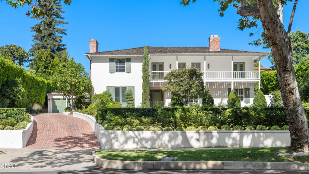 Ideally situated within walking distance to Polytechnic School, Caltech, Erewhon Market, The Shops on Lake, The Langham Hotel, and The Huntington Library & Gardens, this exceptional Monterey Colonial residence offers a rare opportunity to own a piece of Pasadena's architectural heritage in one of its most coveted neighborhoods.Perched on a gentle knoll above the street, this elegant home was designed in 1930 by renowned architect Garrett Van Pelt Jr. Timeless and full of character, it showcases hallmark features of its distinguished style--gracious proportions, hardwood floors, French doors, and an abundance of natural light throughout.The main level offers refined yet welcoming living spaces, including a formal living room and dining room. Just off the foyer, a versatile ensuite bedroom with a fireplace can serve as a cozy den, home office, or guest suite. The updated kitchen, equipped with stainless steel appliances, adjoins a sunny breakfast room and opens into a spacious family room featuring a built-in bar, full bath, and French doors that seamlessly connect to the backyard oasis.Upstairs, the private quarters include a Jack and Jill bedroom suite and a serene primary suite complete with two walk-in-sized closets and a luxuriously renovated bath. A wide, shaded balcony overlooks the enchanting backyard gardens and lap-style pool--an idyllic setting for both entertaining and quiet relaxation.Freshly repainted and thoughtfully updated, this distinguished residence combines historical significance with modern comfort for truly refined living in the heart of Pasadena.